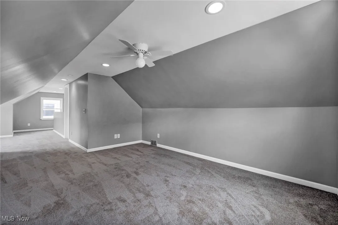 Additional living space with carpet floors, vaulted ceiling, a ceiling fan, and recessed lighting