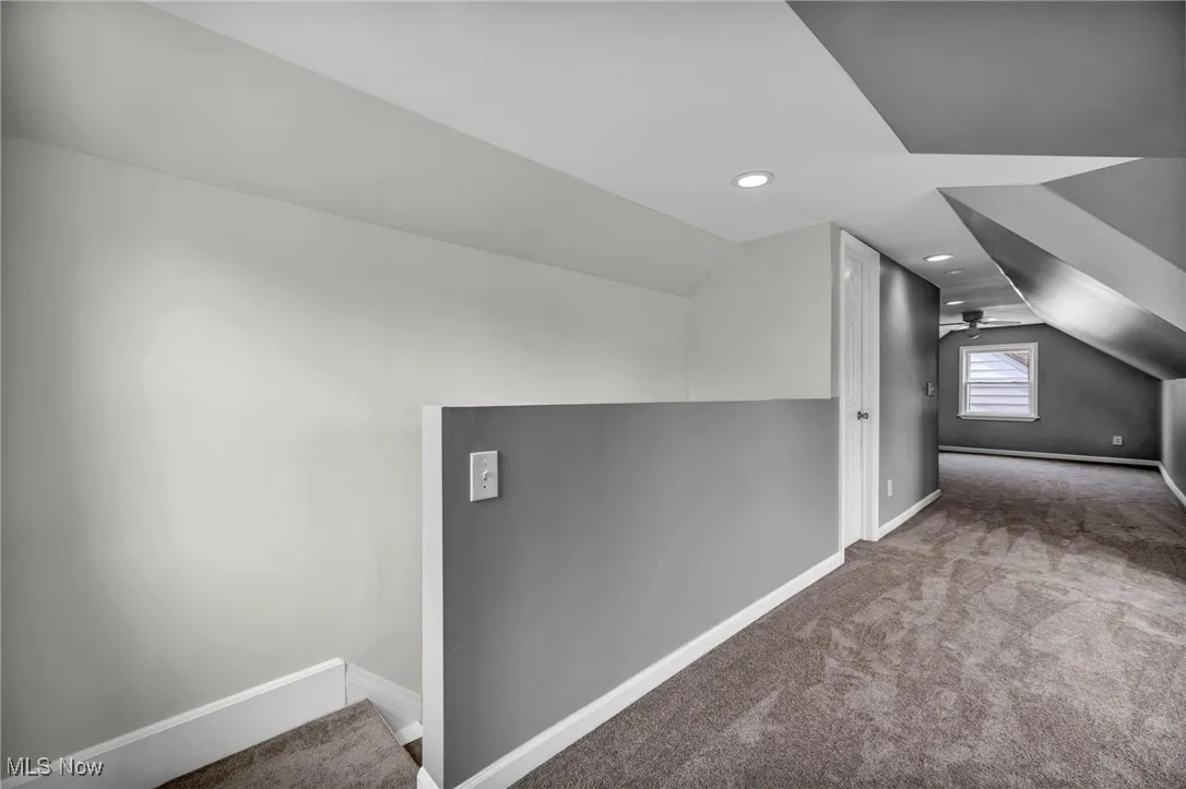 Additional living space featuring lofted ceiling, carpet, and recessed lighting