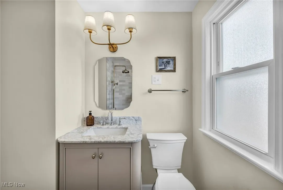 Bathroom featuring vanity and a tile shower