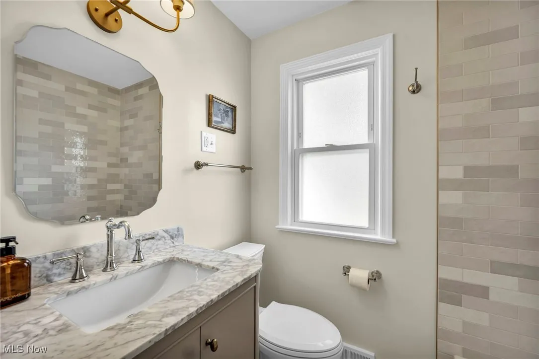 Full bath with vanity and toilet