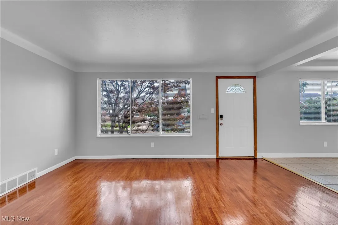 Entrance foyer with wood finished floors and a textured ceiling