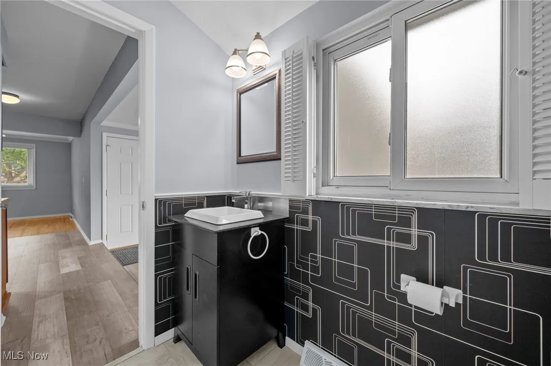 Bathroom with vanity and wood finished floors