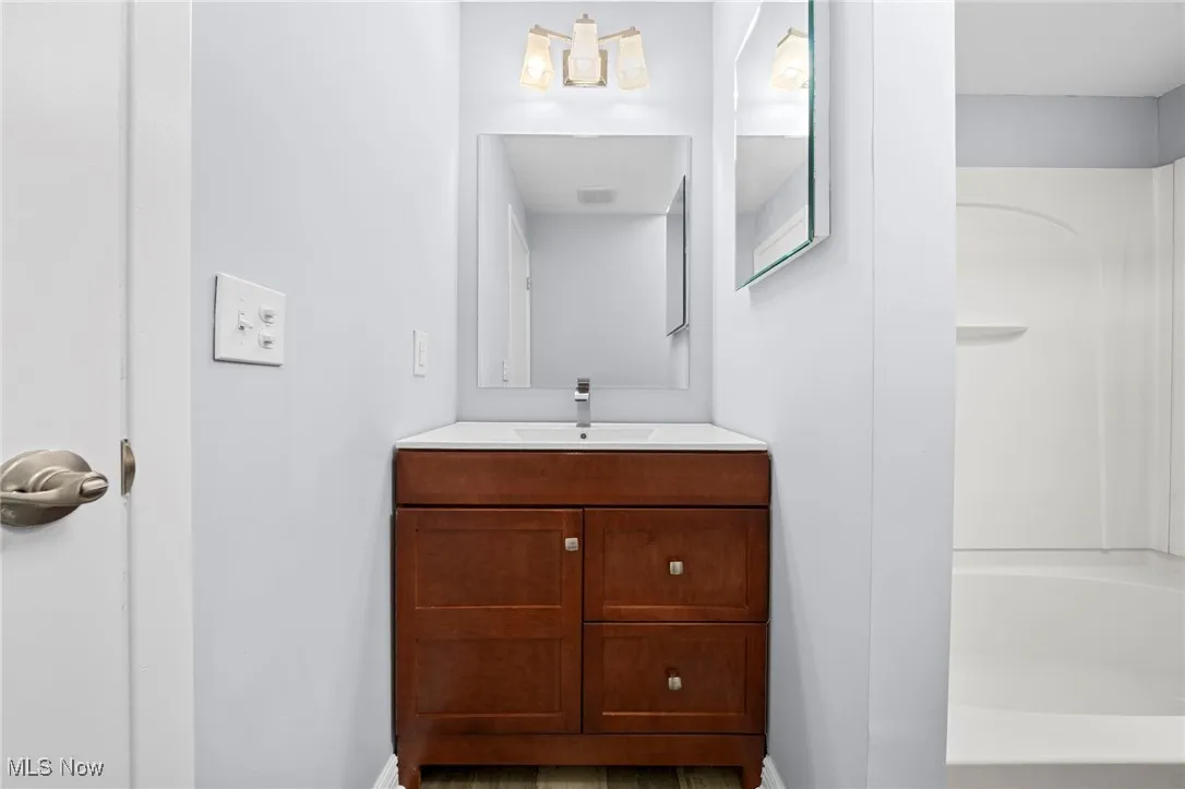 Bathroom featuring vanity and tub / shower combination