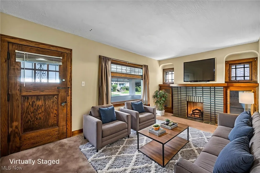 Carpeted living room with a decorative fireplace.