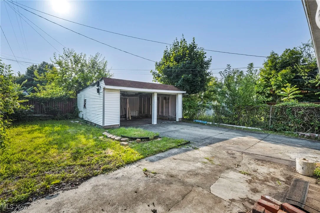 Garage featuring a carport and driveway