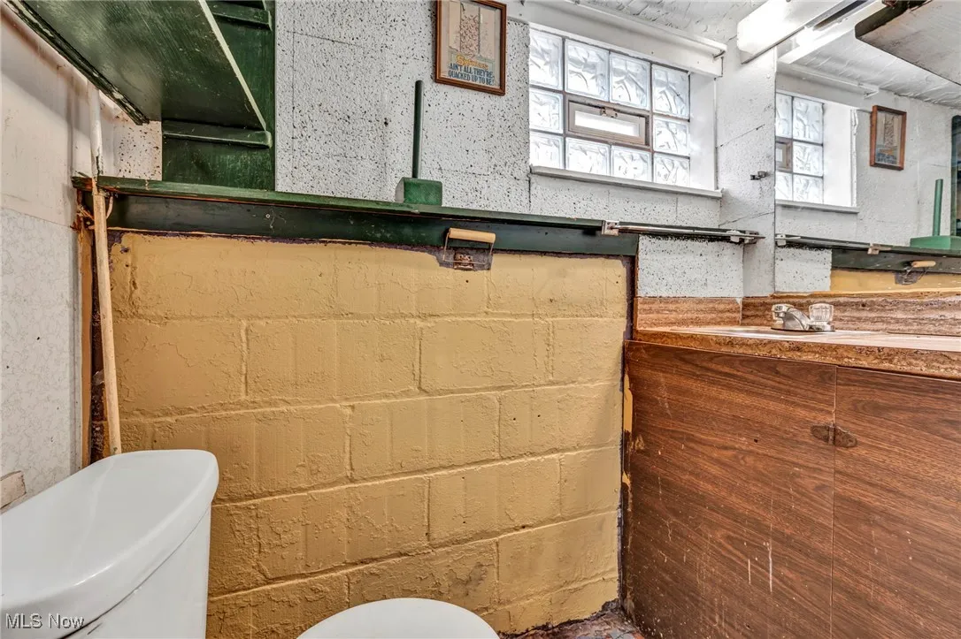 Half bathroom with toilet and vanity.