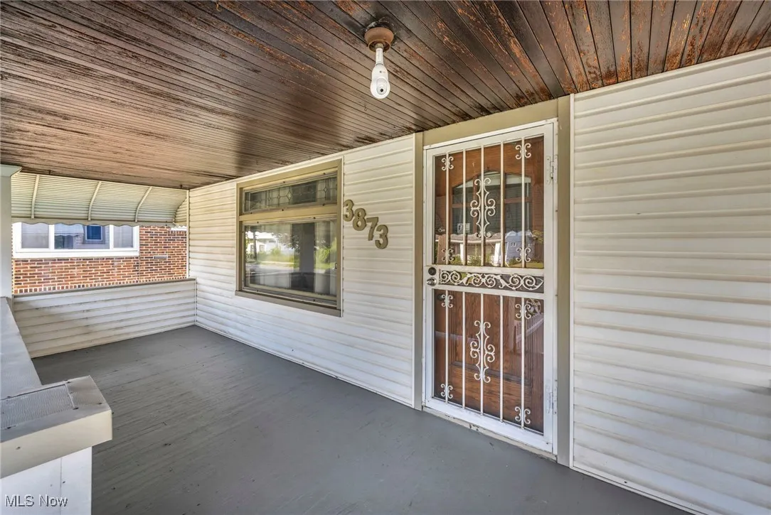 Entrance to property featuring covered porch.