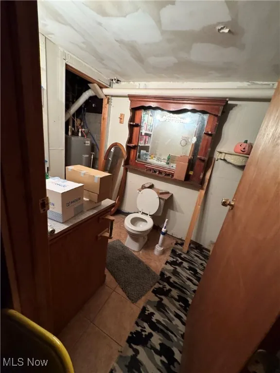 Bathroom featuring tile patterned flooring and water heater