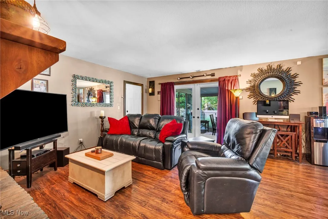 Living area with french doors and dark wood finished floors