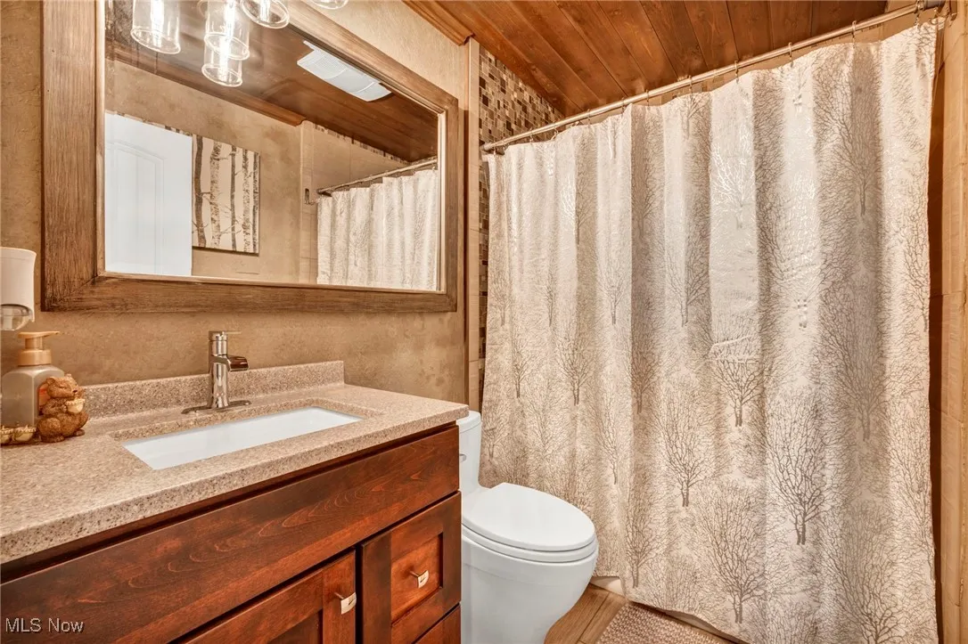 Bathroom with vanity and a shower with shower curtain