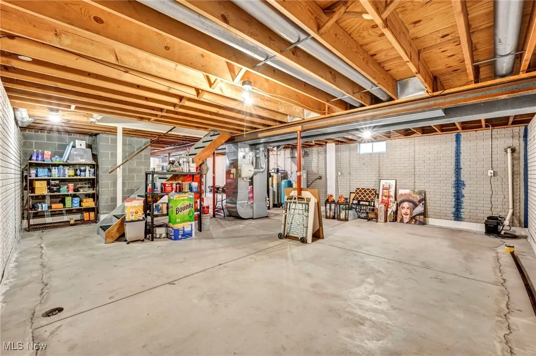 Unfinished basement featuring heating unit