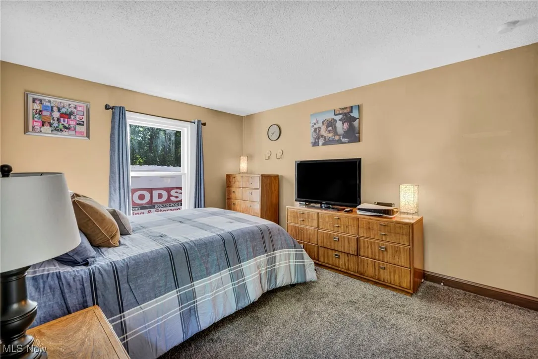 Bedroom with carpet flooring and a textured ceiling
