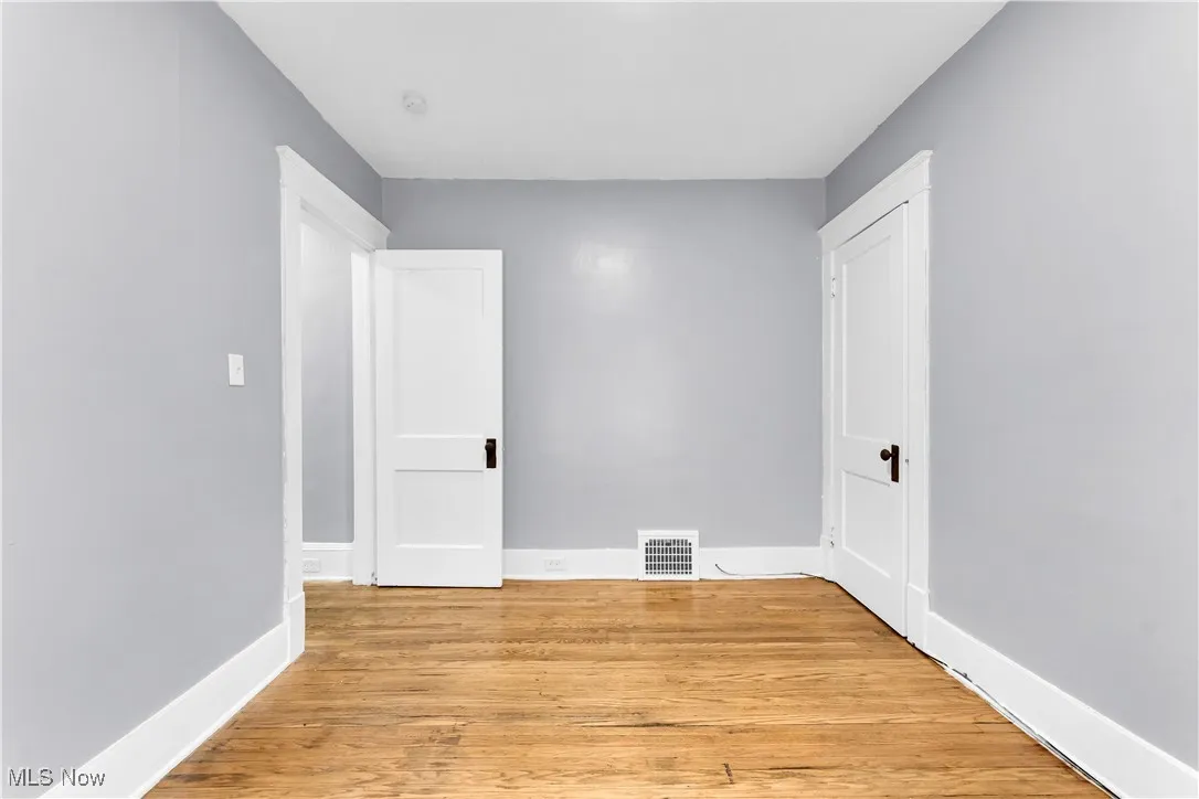 Spare room featuring light wood-style floors and baseboards