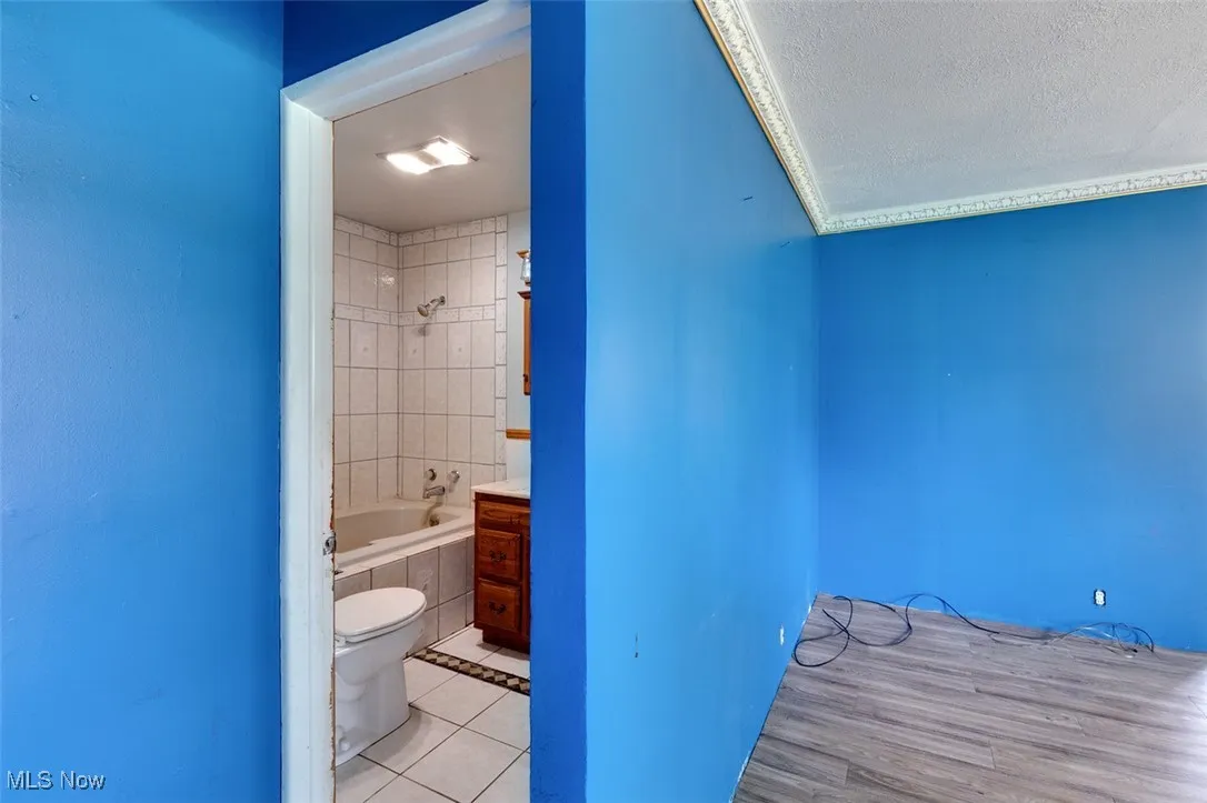 Bathroom featuring tile patterned flooring and shower / tub combination