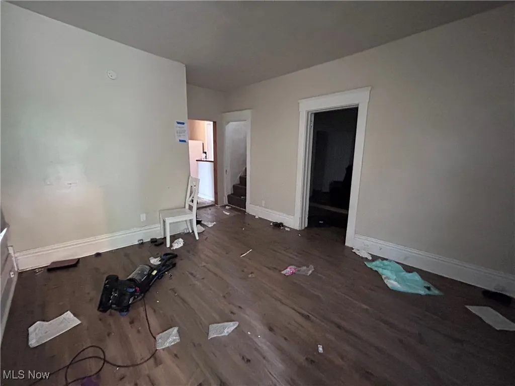 Unfurnished bedroom featuring baseboards and wood finished floors