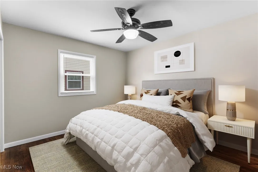 Bedroom with baseboards, ceiling fan, and wood finished floors