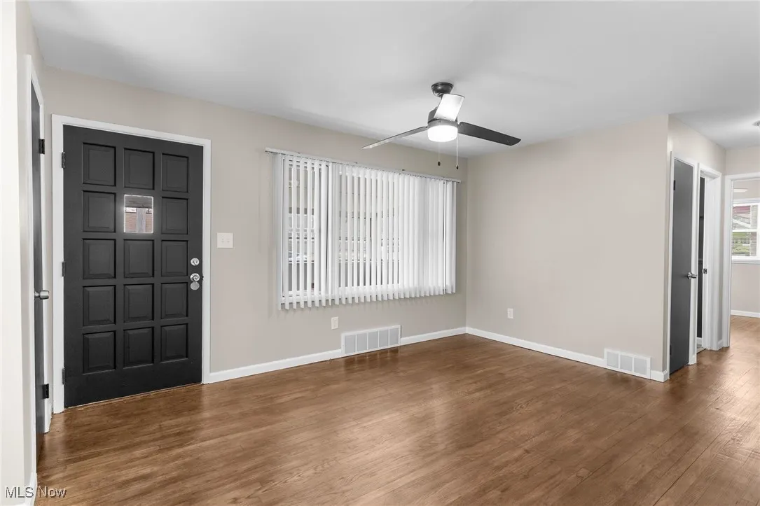 Entryway featuring baseboards, ceiling fan, visible vents, and wood finished floors