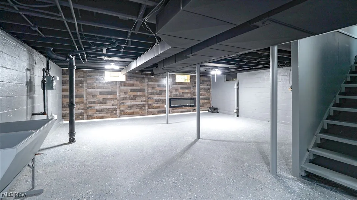 Basement featuring stairway and a sink