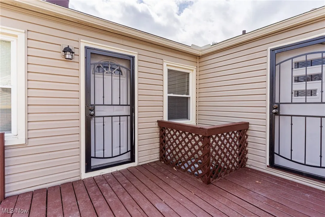 View of wooden deck and entry to fourth bedroom