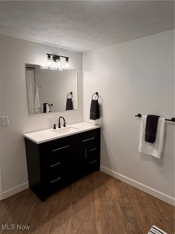 Bathroom with vanity, hardwood