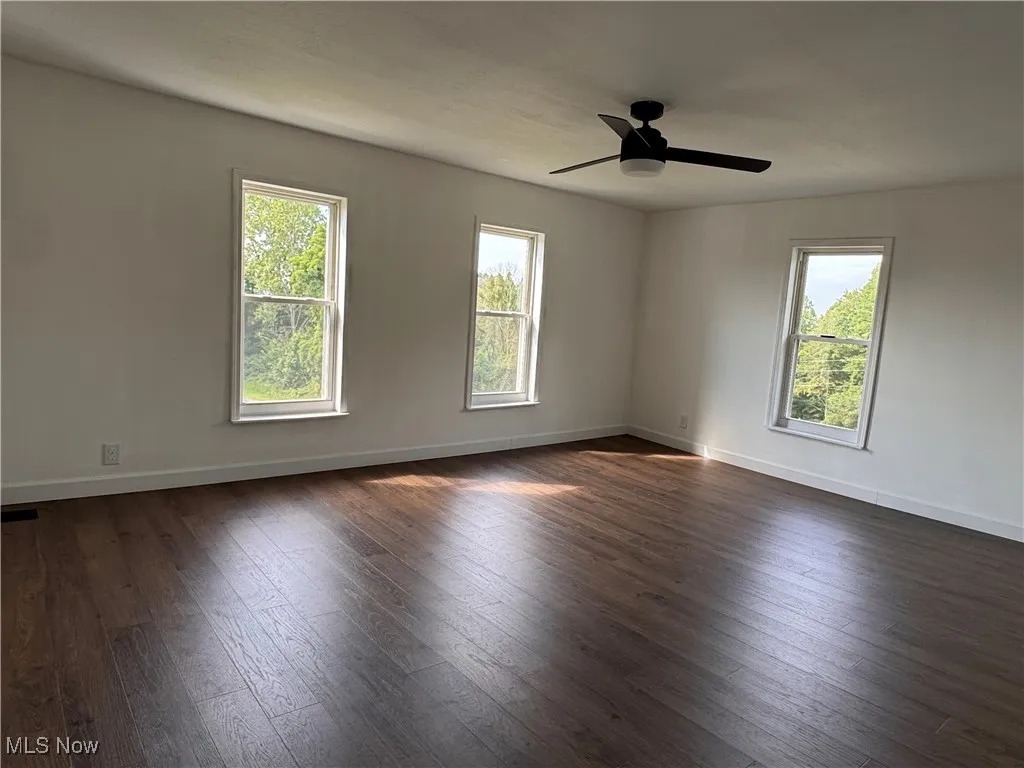 Bedroom featuring dark wood-style flooring and a ceiling fan