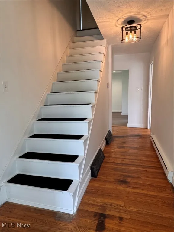 Stairway featuring a wood finished floors
