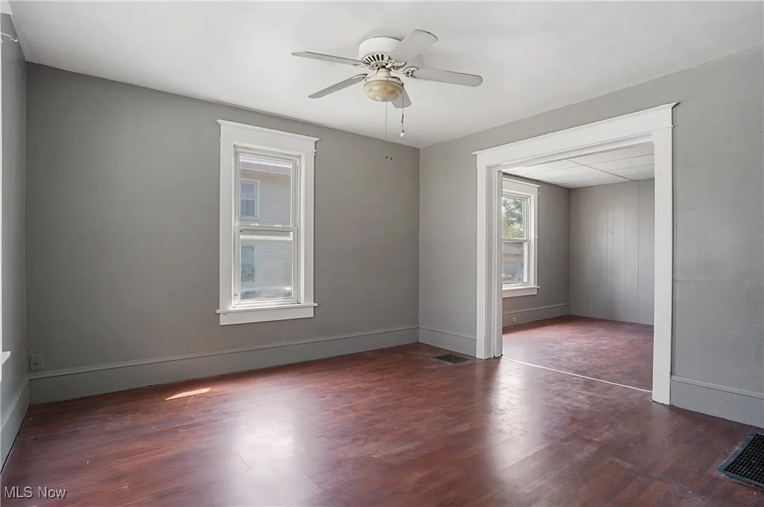 Spare room with wood finished floors and a ceiling fan