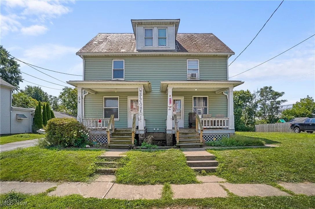 American foursquare style home featuring covered porch