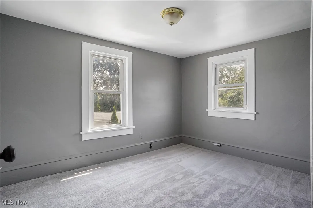 Unfurnished room featuring carpet flooring