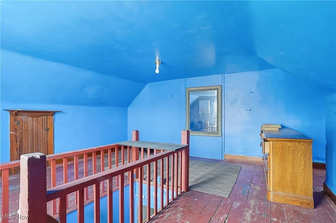 Bonus room featuring lofted ceiling and wood-type flooring