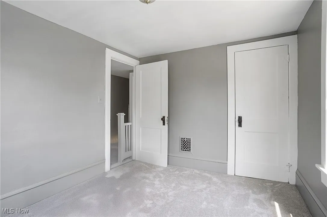 Unfurnished bedroom with carpet