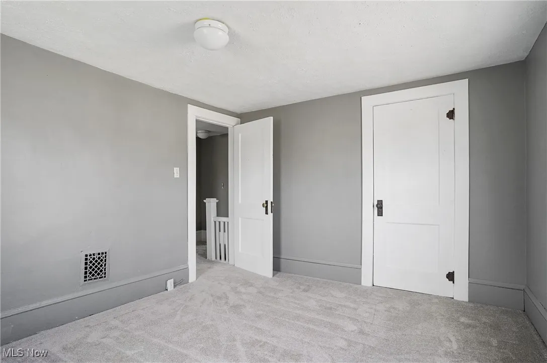 Unfurnished bedroom featuring carpet floors and a textured ceiling