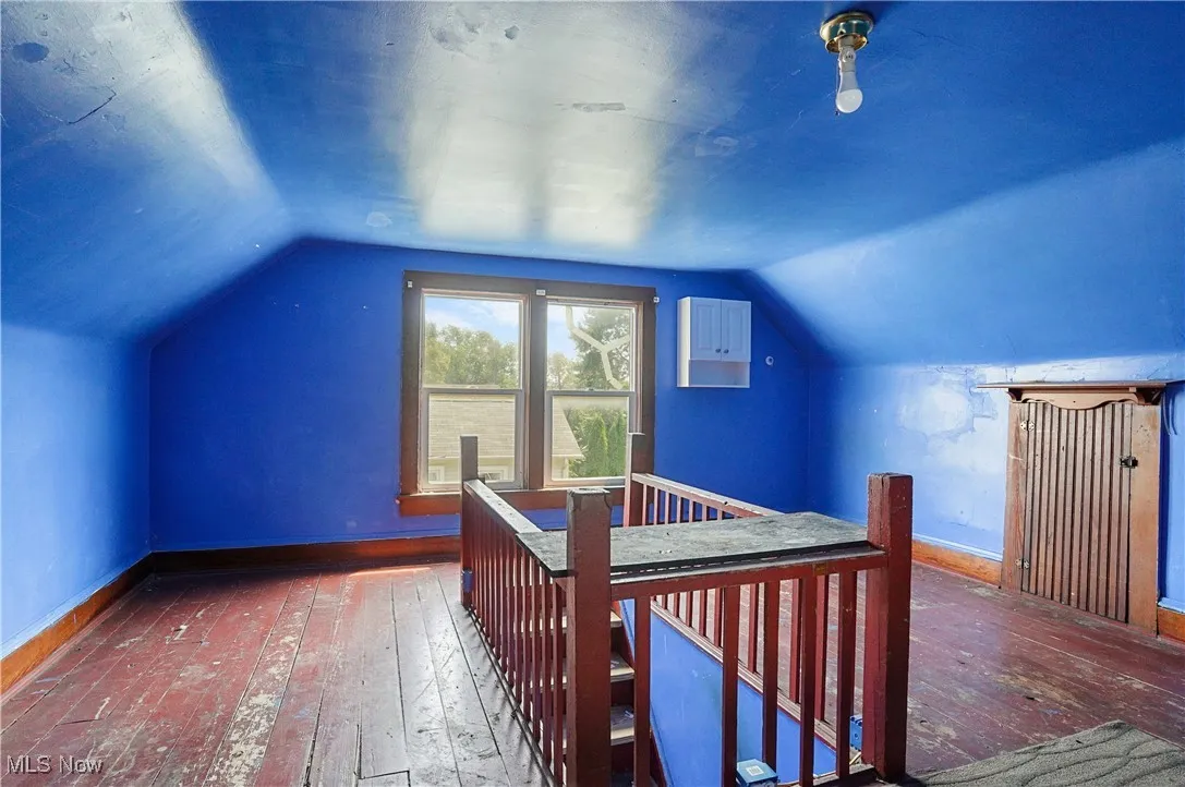 Bonus room featuring hardwood / wood-style flooring and lofted ceiling