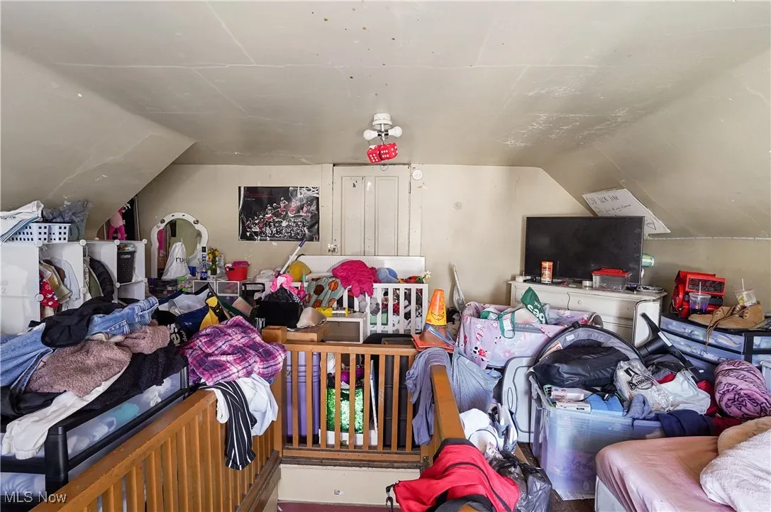 Bedroom with lofted ceiling
