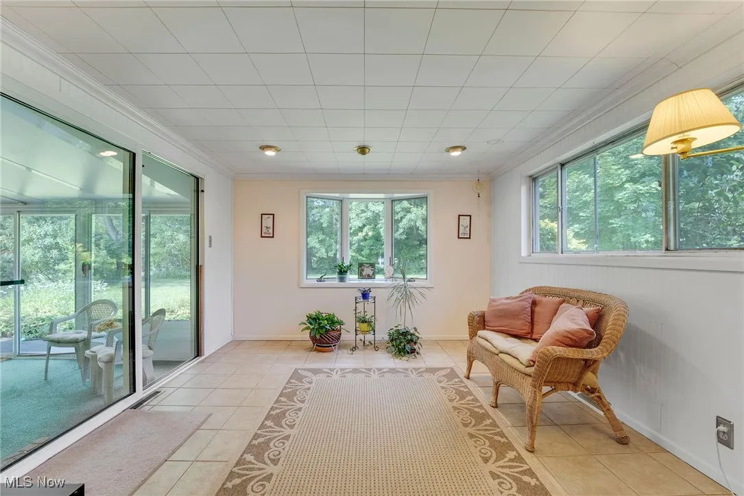 Adjacent to the dining room is a four-season room filled with charm and natural light