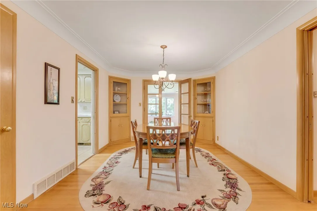 Formal dining area highlighted by hardwood floors and two built-in corner china cabinets