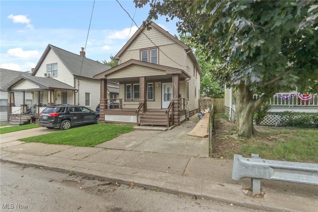 Bungalow-style home with a porch and a front lawn