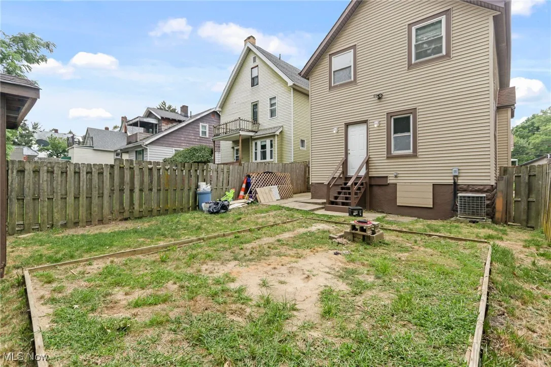 Back of property featuring a fenced backyard and a residential view