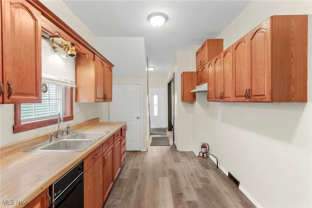 Kitchen featuring plenty of natural light, light wood-style floors, and light countertops