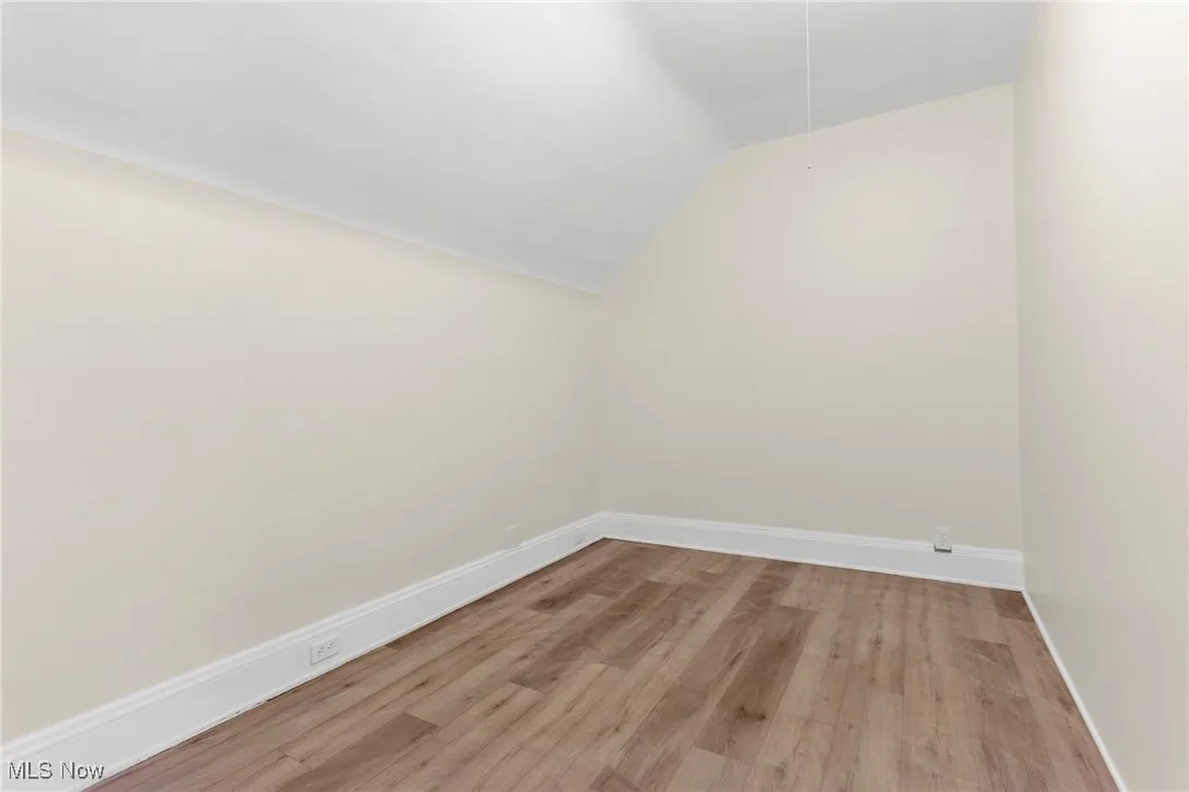 Bonus room featuring vaulted ceiling and light wood-style floors
