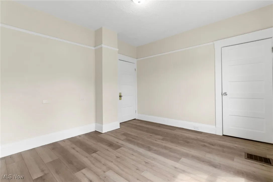 Unfurnished bedroom featuring baseboards and light wood-style flooring