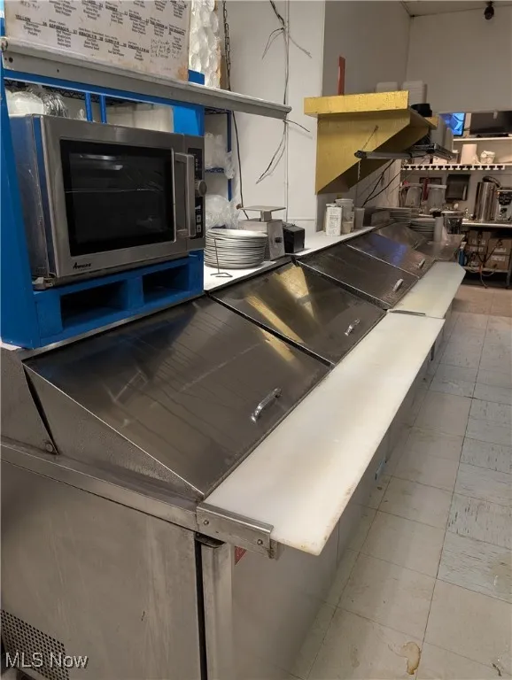 Kitchen featuring stainless steel microwave