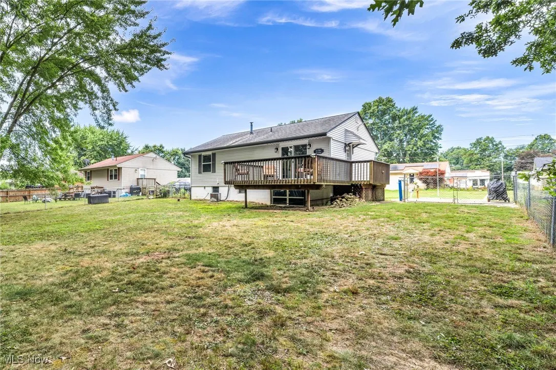 Back of house featuring a deck, a gate, and a fenced backyard