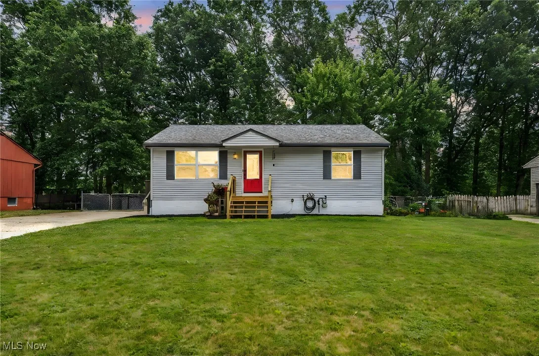 View of front of property featuring view of scattered trees