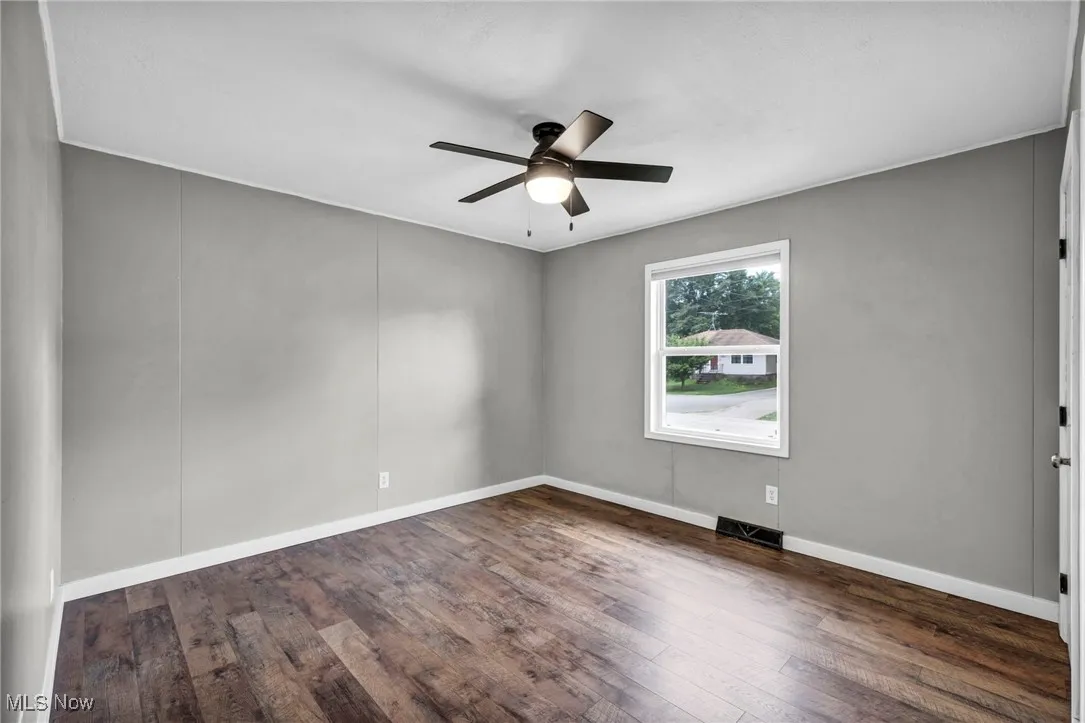 Unfurnished room featuring wood finished floors and ceiling fan