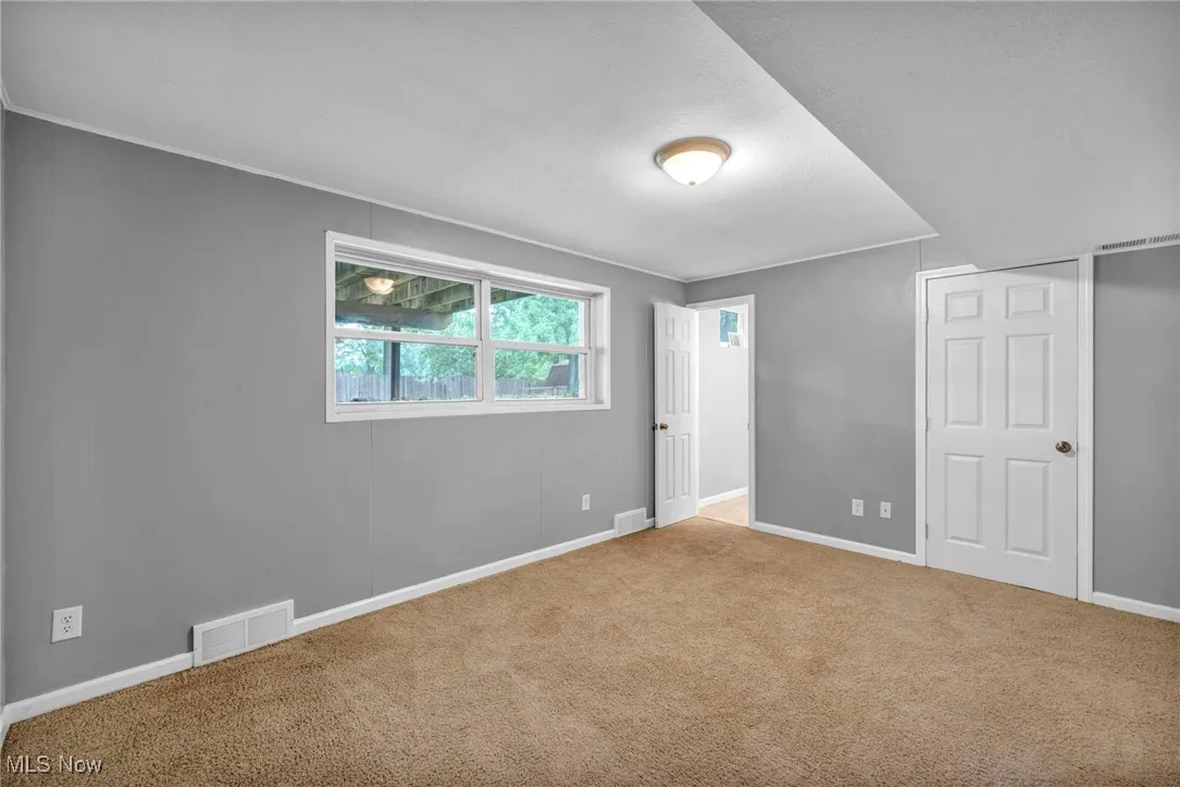Unfurnished bedroom featuring carpet and baseboards