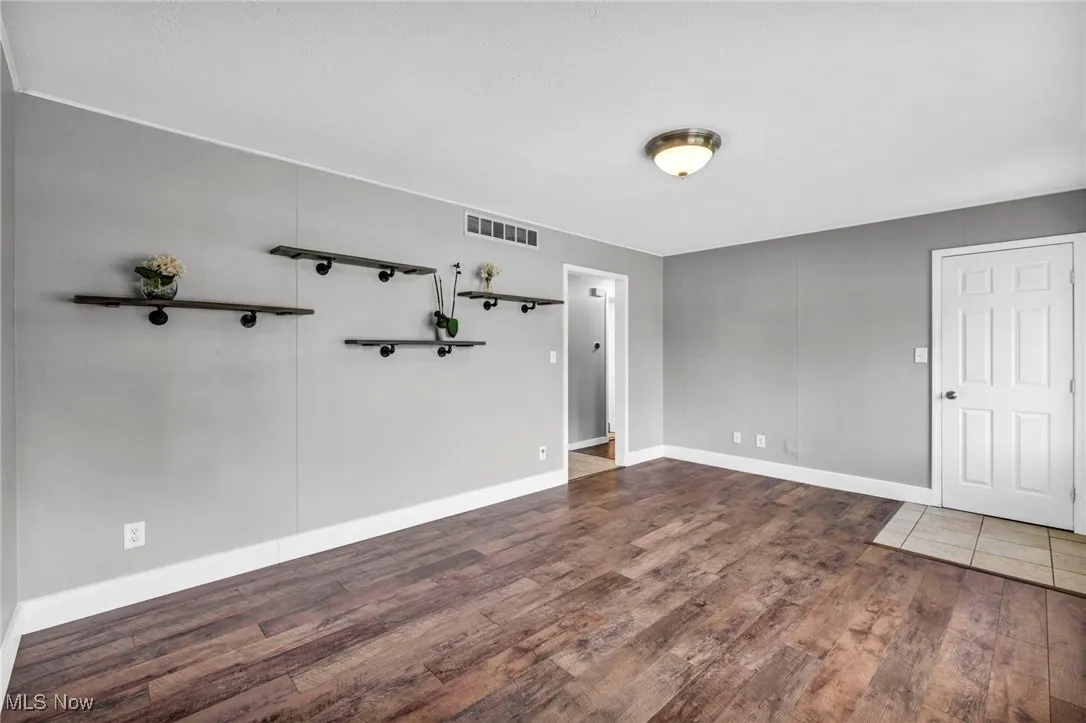 Spare room with wood finished floors and baseboards