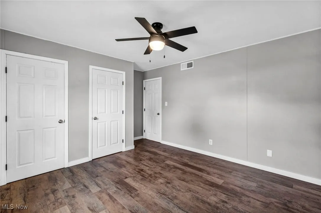 Unfurnished bedroom with wood finished floors and ceiling fan