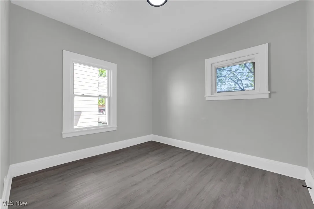 Unfurnished room with dark wood finished floors