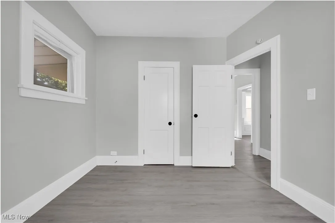 Unfurnished bedroom featuring wood finished floors and a closet